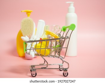 Shopping Basket With Baby Pacifier, Scissors And Duck On Pink Background With Baby Supplies And Cosmetics ,