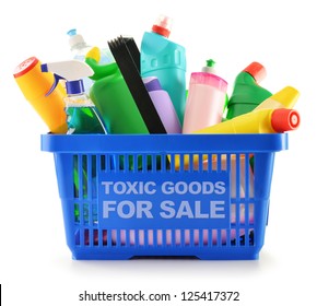 Shopping basket with detergent bottles and chemical cleaning supplies isolated on white