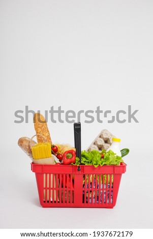 shopping basket full of healthy food over white background with copy space