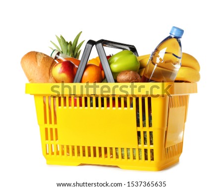 Shopping basket with grocery products on white background