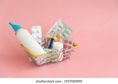 Shopping basket with medicinal pills and tablets closeup Isolated on light pink background.