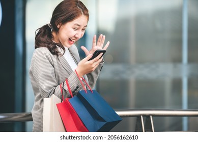 shopping, buying, lifestyle concepts young women with colorful shopping bags and smartphones enjoying shopping