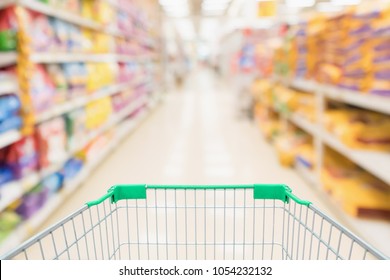 Shopping Cart With Abstract Blur Supermarket Discount Store Aisle And Pet Food Product Shelves Interior Defocused Background