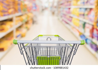 Shopping Cart With Abstract Blur Supermarket Discount Store Aisle And Pet Food Product Shelves Interior Defocused Background