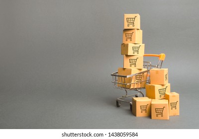 Shopping cart and boxes with drawing of smaller carts. goods sale. commerce, online shopping. Purchasing power, delivery order. E-commerce, sales and sale of goods through online trading platforms.