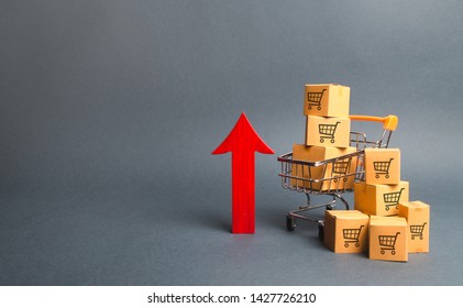 Shopping cart with cardboard boxes with a pattern of trading carts and a red up arrow. Growth wholesale and retail. Improving consumer sentiment, economic growth. Rising prices for goods, inflation - Shutterstock ID 1427726210