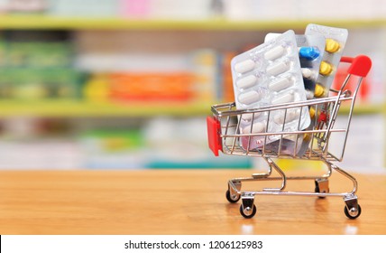 Shopping Cart Filled With Blister Packs Of Medicine On Pharmacy Drugstore Shelves Background.Online Medical Concept.