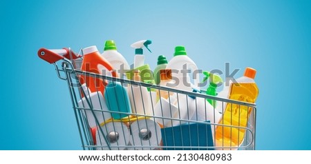 Shopping cart full of detergents, hygiene and housekeeping concept