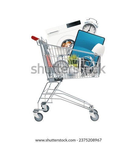 Shopping cart full of household goods, appliances and electronics: sales and retail concept