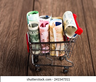 Shopping Cart Full Of Money (dollar, Euro). Multi Currency Basket Concept