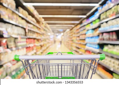 shopping cart in supermarket aisle with product shelves interior defocused blur background