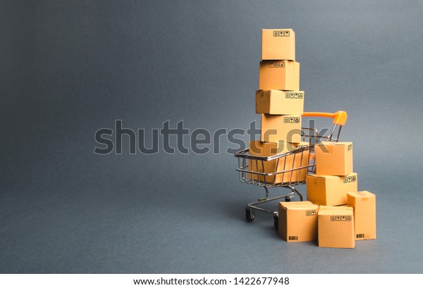 Shopping cart supermarket with boxes. Sales of\
products. The concept commerce, online shopping. Purchasing power,\
delivery order. E-commerce, sales and sale of goods through online\
trading platforms.