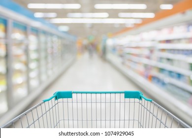 Shopping Cart View With Supermarket Aisle Abstract Blur Frozen And Dairy Products In Refrigerator Shelves Background