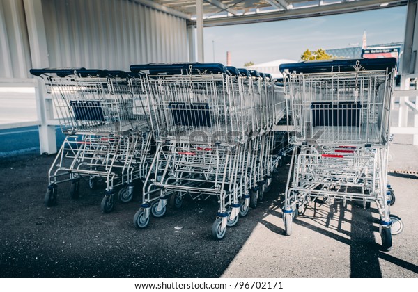 shopping carts. metal shopping carts\
at the back of a store. shopping car row at a\
supermarket
