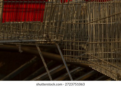 Shopping carts pattern, Multiple shopping carts with red handles and shiny metallic wire structures arranged in repetitive pattern