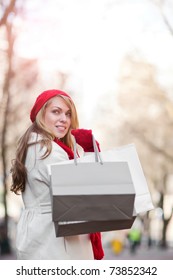 A Shopping Caucasian Woman Carrying Shopping Bags At An Outdoor Shopping Mall