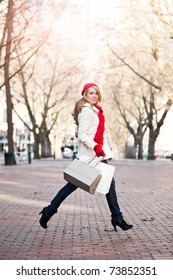 A Shopping Caucasian Woman Carrying Shopping Bags At An Outdoor Shopping Mall