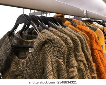 Shopping. Color Winter Warm knitted sweaters in shop. - Powered by Shutterstock