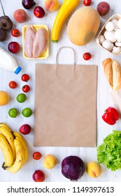 Shopping Concept. Set Of Various Groceries With Paper Bag On White Wooden Table, Top View. Cooking Food Background. Flat Lay Of Fresh Foods. Overhead, From Above. 