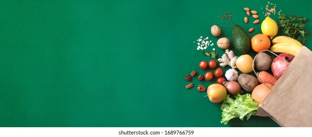 Shopping or delivery healthy food background. Healthy vegan vegetarian food in paper bag vegetables and fruits on green, copy space. Food supermarket and clean vegan eating concept. - Shutterstock ID 1689766759