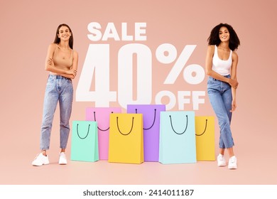Shopping Discount Offer. Two Stylish Young Women Advertising 40 Percent Sale Off, Posing With Colorful Shopper Bags Over Beige Studio Background. Full Length Shot, Collage - Powered by Shutterstock