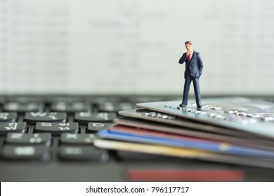 Shopping and e-commerce concept. Miniature people : Close up of miniature businessman on smart card and laptop keyboard. - Powered by Shutterstock