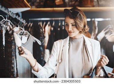 Shopping, fashion and woman with a sale, boutique and discount items with retail, client and luxury. Female person, customer and shopper with price tag, store and outfit choice with clothes selection