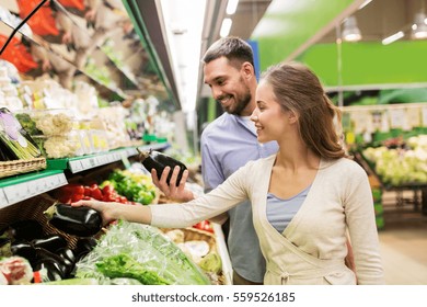 shopping, food, sale, consumerism and people concept - happy couple buying avocado at grocery store or supermarket - Powered by Shutterstock