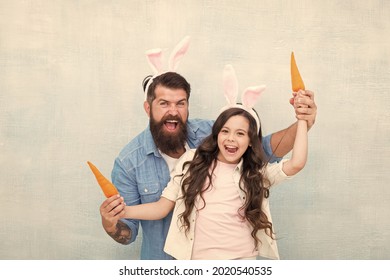 Shopping Grocery. Funny Team. Spring Holiday. Celebrate Easter. Easter Food. Girl And Dad Bunny Ears. Happy Family Wear Bunny Ears. Easter Fun And Happiness. Father And Daughter Play With Carrots