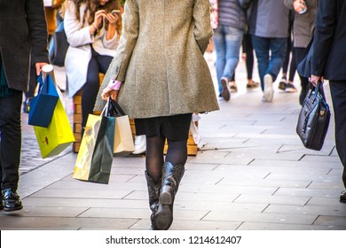 A Shopping High Street Scene With Woman Carrying Shopping Bag