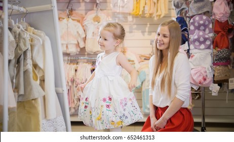 Shopping For Kids. Mom Admires Her Daughter