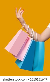 Shopping Mall. Black Friday. Unrecognizable Woman With Pink And Blue Bags. Isolated On Orange. Family Gifts. Cyber Monday. Sale And Discount