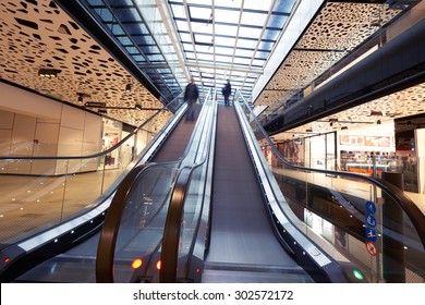 Shopping mall center escalators. Zoom blur movement.