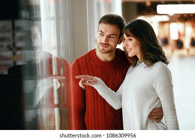 Shopping Mall. Man And Woman Looking Through Store Window