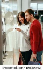 Shopping Mall. Man And Woman Looking Through Store Window