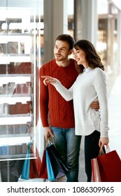 Shopping Mall. Man And Woman Looking Through Store Window