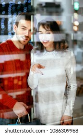 Shopping Mall. Man And Woman Looking Through Store Window