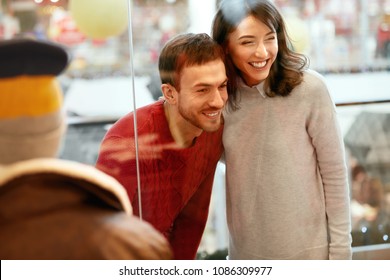 Shopping Mall. Man And Woman Looking Through Store Window