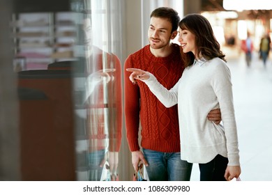 Shopping Mall. Man And Woman Looking Through Store Window