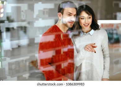 Shopping Mall. Man And Woman Looking Through Store Window