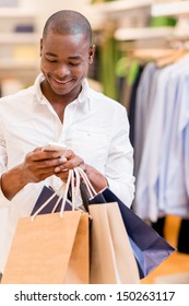 Shopping Man Texting On His Phone At A Store 