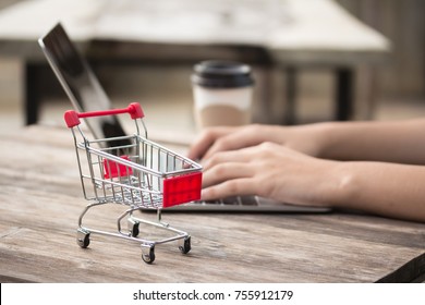 Shopping online with computer and cart