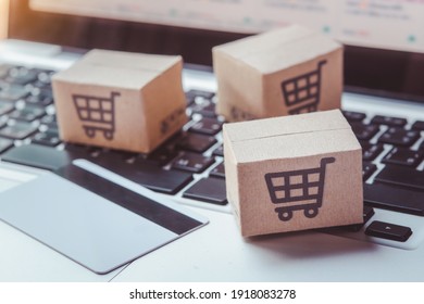 Shopping Online. Credit Card And Cardboard Box With A Shopping Cart Logo On Laptop Keyboard. Shopping Service On The Online Web. Offers Home Delivery