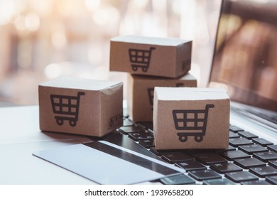 Shopping Online. Credit Card And Cardboard Box With A Shopping Cart Logo On Laptop Keyboard. Shopping Service On The Online Web. Offers Home Delivery