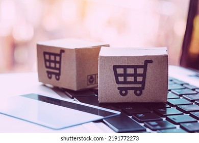 Shopping online. Credit card and cardboard box with a shopping cart logo on laptop keyboard. Shopping service on The online web. offers home delivery - Shutterstock ID 2191772273