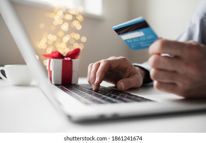 Shopping Online During Holidays. Man Using Laptop Computer And Credit Card, Ordering Christmas Gifts. Shopping, Internet Banking, Store Online, Payment, Surprise, Spending Money, Holidays Concept