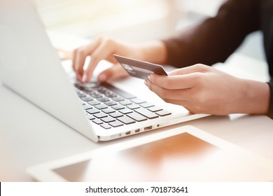 shopping and online payment by using notebook with sun light effect