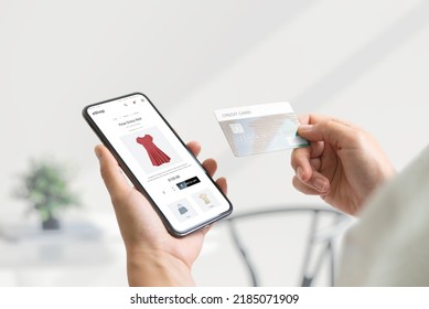 Shopping online with smart phone and credit card concept. Modern e-commerce web page with with women's clothing - Shutterstock ID 2185071909