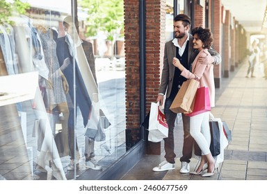 Shopping, retail window and couple in city with bags for clothing sale, discount deal and store promotion. Fashion, boutique mall and happy man and woman for bonding, travel and tourism on weekend - Powered by Shutterstock