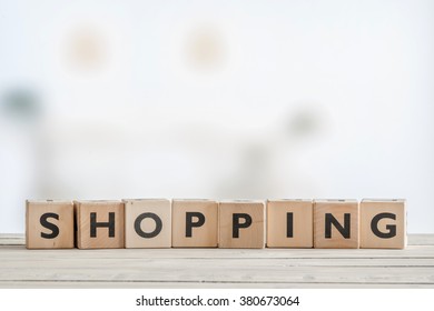 Shopping sign on a wooden table in bright daylight - Shutterstock ID 380673064